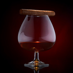 cigar on a glass of cognac