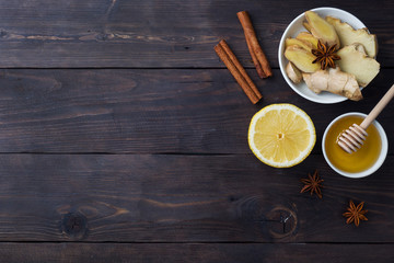 White Cup with natural herbal tea ginger lemon and honey cinnamon. Energy vitamin drink is used for colds.Dark wooden background copy space