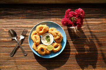crispy calamari rings from top view on wood table