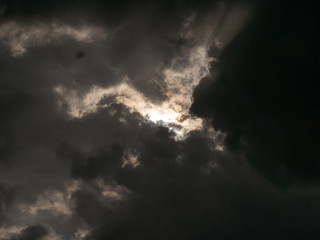 Rising Sun behind The Gray Clouds