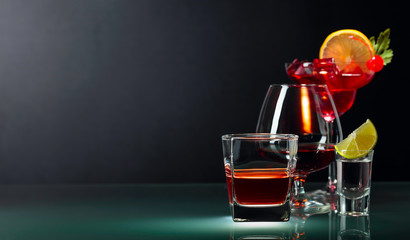 Various alcoholic drinks on a black background.