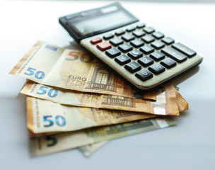 Banknotes and Calculator, Euro Banknotes on White Background