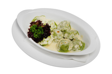 Homemade Meat Dumplings with sour cream and greens on a white isolated background