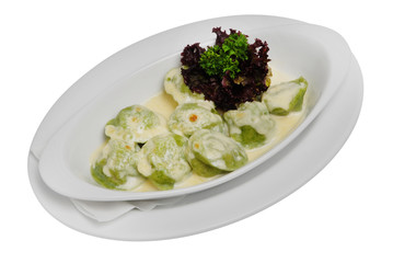 Homemade Meat Dumplings with sour cream and greens on a white isolated background