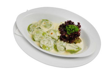 Homemade Meat Dumplings with sour cream and greens on a white isolated background