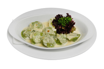 Homemade Meat Dumplings with sour cream and greens on a white isolated background