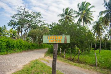 Sign marking the beginning of the road to Engenho do Amparo (old sugar cane farm) in Ilha de Itamaraca - Pernambuco, Brazil