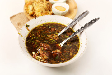traditional indonesia food rawon with eggs from top view.