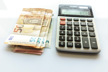 Banknotes and Calculator, Euro Banknotes on White Background