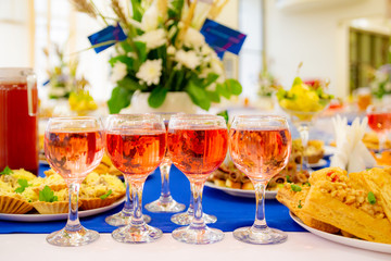 Rose wine in glasses on the Banquet table. Delicacies and snacks at the buffet. Catering.