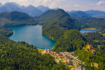 Aerial view on Alpsee lake and Hohenschwangau Castle, Bavaria, Germany. Concept of traveling and hiking in German Alps.