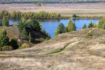 Autumn panoramic landscape with river and hills cloudy day in Konstantinovo village Russia