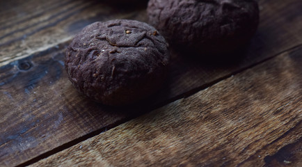 brown rye buns with cumin on a wooden table