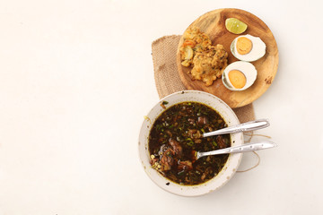 traditional indonesia food rawon with eggs from top view.