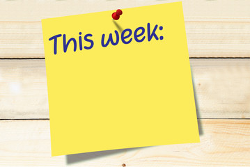 This week note on yellow paper post it pinned to a wooden board
