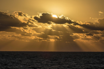 Naklejka na ściany i meble Sun sends sunbeams to the Caribbean Sea.