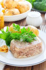 Jellied turkey meat on a white plate, selective focus