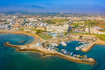 Obraz premium Cyprus. Protaras. The Port Of Paralimni. Pernera. Panorama of the Mediterranean coast from a height. Top view of kalamies beach. Church of St. Nicholas in Cyprus. Cyprus beach resort. Boat Harbor.