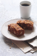 Vegan Square Chocolate Cake with Apples and Walnuts, on a plate, on a grey background.