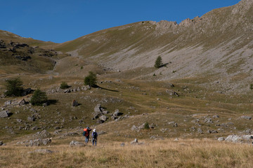 Hiker and mountain landscape in summer in the French Alps