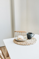 Morning breakfast with coffee and cake on table. Minimal interior design concept.