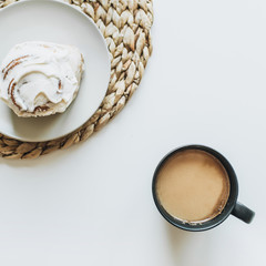 Morning breakfast with coffee and cake on white table. Flat lay, top view minimal food concept.