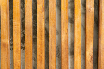 Wooden fence on cemen wall background.