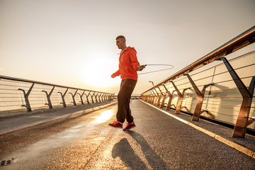 Fit sportsman exercising with a jumping rope