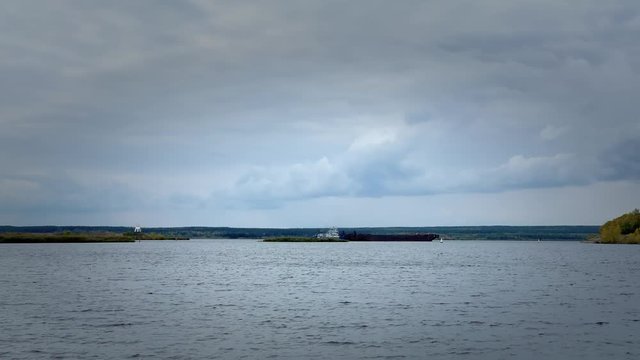 NABEREZHNYE CHELNY, RUSSIA - SEPTEMBER, 29, 2018: Tug that is dragging large ship. 3840x2160 UHD Free footage stoke
