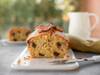 delicious homemade cake with pears, chocolate, nuts on a light blurred background