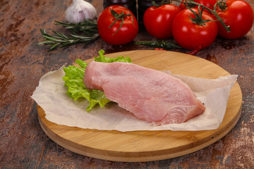 Raw Turkey steak served rosemary