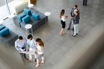 Group of coworkers working together on business project in modern office