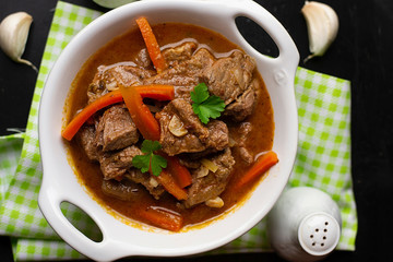 Slow cooked beef stew with carrots in tomato gravy