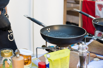 Chef preparing delicious organic pasta dish outdoor.