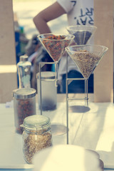 Organic teas displayed in martini glasses at outdoor market place.