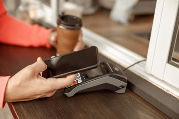 Man making a payment in a cafe