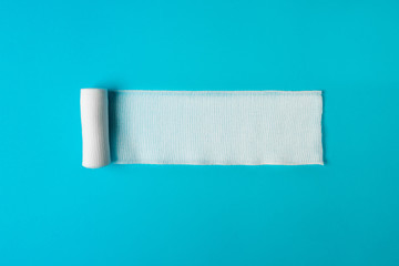 Medical bandage untwisted on a blue background.Health concept. Healthy lifestyle concept. The...