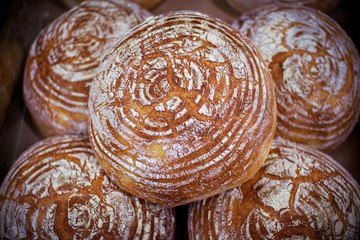 Freshly baked homemade bread with golden crispy crust. Food background.
