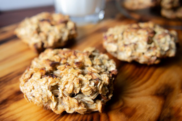 oatmeal cookies with apples and milk on a wooden board