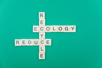 Ecology and green planet minimalistic concept. Isolated wooden letter blocks with word cloud Reduce Reuse and Recycle principle