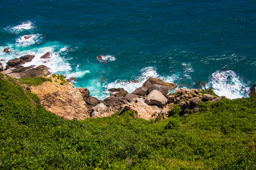 Beautiful rocks and boulders on the small Boundary island near Hainan island, blue South China sea, China country