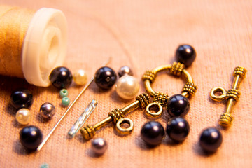 Colorful glass beads and crystals. Variety of shapes and colors to make a bead necklace or a string of beads for women. Blurred photo.