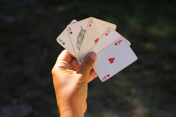 Playing cards in hand, with five aces