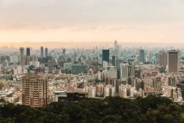 Fototapeta na wymiar Aerial panorama over Downtown Taipei with layers of mountain in background in the dusk from Xiangshan Elephant Mountain in the evening.