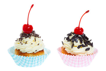 two cupcakes with whipped cream decorated chocolate sprinkles and maraschino cherry isolated on white background