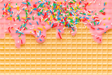 yellow waffle texture with pink icing and sprinkles, background for your design