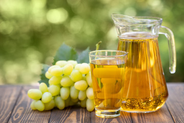 grape juice in glass and jug