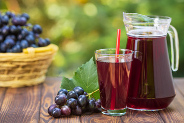 grape juice in glass and jug