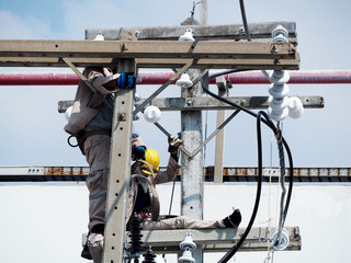 electrician man working at hight and dangerous ,high voltage power line maintenance