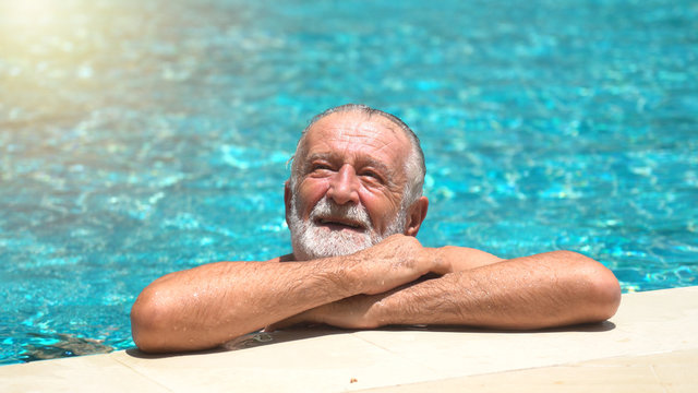 Senior man swimming in  swimming pool